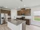 Modern kitchen with island, stainless steel appliances, granite countertops and recessed lighting at 1280 Firefly Field Trce, Lawrenceville, GA 30045