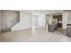 Open-concept living room with view of the kitchen and staircase at 1280 Firefly Field Trce, Lawrenceville, GA 30045