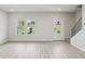 Open-concept living room with staircase and plenty of natural light at 1280 Firefly Field Trce, Lawrenceville, GA 30045