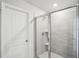 A modern bathroom featuring a glass shower, white tiled walls, and modern fixtures creates a clean and inviting space at 1280 Firefly Field Trce, Lawrenceville, GA 30045