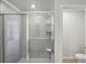 Bathroom glass-enclosed shower shows tile walls at 1290 Firefly Field Trce, Lawrenceville, GA 30045