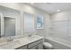 Bathroom with double vanity, large mirror, white tiled bathtub and sink at 1290 Firefly Field Trce, Lawrenceville, GA 30045