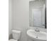 Small bathroom with sleek, modern fixtures, toilet, sink and mirror at 1290 Firefly Field Trce, Lawrenceville, GA 30045