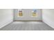Neutral bedroom with two windows providing natural light at 1290 Firefly Field Trce, Lawrenceville, GA 30045