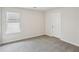 Bedroom features a window and carpet and door to another area at 1290 Firefly Field Trce, Lawrenceville, GA 30045