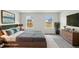 Staged main bedroom offers a calming design with contemporary furniture at 1290 Firefly Field Trce, Lawrenceville, GA 30045