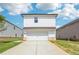 Modern two-story home showcasing a white exterior, attached two-car garage and beautiful lawn at 1290 Firefly Field Trce, Lawrenceville, GA 30045