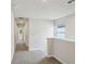 Hallway with plush carpet and plenty of light; doorways lead to other rooms at 1290 Firefly Field Trce, Lawrenceville, GA 30045