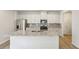 Modern kitchen with white cabinets, granite countertops, stainless steel appliances, and a kitchen island at 1290 Firefly Field Trce, Lawrenceville, GA 30045