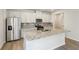 Bright kitchen featuring stainless steel appliances, granite countertops, white cabinets, and center island at 1290 Firefly Field Trce, Lawrenceville, GA 30045