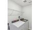 Laundry room with wire shelving and Whirlpool washer and dryer at 1290 Firefly Field Trce, Lawrenceville, GA 30045
