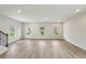 Bright, open-concept living room featuring sleek flooring, neutral walls, and plenty of natural light at 1290 Firefly Field Trce, Lawrenceville, GA 30045