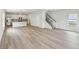 Open-concept living space showcases the modern flooring, staircase, and kitchen in neutral tones at 1290 Firefly Field Trce, Lawrenceville, GA 30045