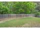 A spacious backyard with a wooden fence and vibrant green grass, offering a private outdoor space at 1670 Cooper Lakes Dr, Grayson, GA 30017
