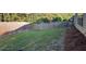 Spacious backyard with a wood fence and grassy area at 1670 Cooper Lakes Dr, Grayson, GA 30017