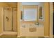 Bathroom featuring a garden tub, enclosed shower, and a built-in shelf at 1670 Cooper Lakes Dr, Grayson, GA 30017