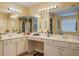 Spacious bathroom with double vanity, countertop, and mirrors with bright lighting at 1670 Cooper Lakes Dr, Grayson, GA 30017