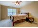 Bedroom with full bed, bedside table, and window with blinds at 1670 Cooper Lakes Dr, Grayson, GA 30017