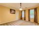 Cozy bedroom featuring soft carpeting, two windows with decorative curtains, and ample natural light at 1670 Cooper Lakes Dr, Grayson, GA 30017
