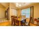 Dining area with hardwood floors, wood table and chairs, and natural light at 1670 Cooper Lakes Dr, Grayson, GA 30017
