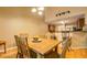 Dining area and kitchen with hardwood floors, bar seating, wooden table, and natural light at 1670 Cooper Lakes Dr, Grayson, GA 30017