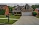 Charming two-story brick home featuring a well-manicured lawn, a two-car garage, and traditional architectural details at 1670 Cooper Lakes Dr, Grayson, GA 30017