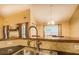 Modern kitchen sink with tile backsplash and dark countertops at 1670 Cooper Lakes Dr, Grayson, GA 30017