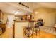 Open concept kitchen with breakfast bar, wooden cabinets, bar stools and hardwood floors at 1670 Cooper Lakes Dr, Grayson, GA 30017