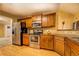 Well lit kitchen featuring stainless steel appliances, wooden cabinets, and hardwood floors at 1670 Cooper Lakes Dr, Grayson, GA 30017