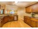 Open kitchen with wood floors, stainless appliances, tile backsplash, and sink beneath window at 1670 Cooper Lakes Dr, Grayson, GA 30017