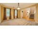 Versatile living room with large windows, carpeting, and easy access to a half bath and staircase at 1670 Cooper Lakes Dr, Grayson, GA 30017