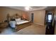 Spacious main bedroom featuring a tray ceiling, carpeted floors, and a luxurious, carved wooden bed frame at 1670 Cooper Lakes Dr, Grayson, GA 30017