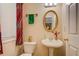 Cozy half bathroom with pedestal sink and decorative mirror at 1670 Cooper Lakes Dr, Grayson, GA 30017
