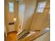 Carpeted stairway featuring a wooden handrail, bright walls, and front door at 1670 Cooper Lakes Dr, Grayson, GA 30017