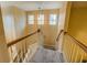 Carpeted stairway with a wooden handrail, bright walls, and overhead lighting at 1670 Cooper Lakes Dr, Grayson, GA 30017