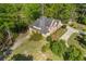 Aerial view of a brick home with circular driveway, mature landscaping, and treed surroundings at 1750 Providence Place Dr, Alpharetta, GA 30009