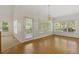 Bright dining room features hardwood floors and large windows with views of the surrounding greenery at 1750 Providence Place Dr, Alpharetta, GA 30009