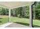 Covered outdoor patio overlooking lush green lawn and wooded area at 241 Martin Spring Rd, Lawrenceville, GA 30045