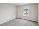 Bright bedroom with a large window, neutral walls, and a comfortable carpeted floor at 241 Martin Spring Rd, Lawrenceville, GA 30045