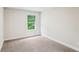 Cozy bedroom with a bright window view, neutral carpet, and ample natural light at 241 Martin Spring Rd, Lawrenceville, GA 30045