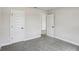 Neutral bedroom with plush carpet, white trim, and bright doors at 241 Martin Spring Rd, Lawrenceville, GA 30045