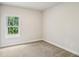 Simple bedroom with neutral carpet and a window overlooking the yard at 241 Martin Spring Rd, Lawrenceville, GA 30045