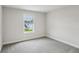 Sunny carpeted bedroom with a backyard view through bright windows and neutral colored walls at 241 Martin Spring Rd, Lawrenceville, GA 30045