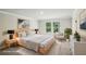 Bright bedroom with a large window, neutral color palette, and contemporary decor at 241 Martin Spring Rd, Lawrenceville, GA 30045