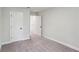 Cozy carpeted bedroom features neutral walls and trim and two bright white doors at 241 Martin Spring Rd, Lawrenceville, GA 30045