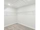 Empty walk-in closet with carpeted floors and wire shelving at 241 Martin Spring Rd, Lawrenceville, GA 30045