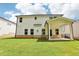 Back of a two-story home showing the covered patio and well-maintained lawn at 241 Martin Spring Rd, Lawrenceville, GA 30045