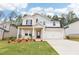 Charming two-story home with a brick facade, manicured lawn, and a two-car garage, offering curb appeal at 241 Martin Spring Rd, Lawrenceville, GA 30045