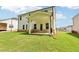 Rear exterior of home with covered patio and spacious backyard at 241 Martin Spring Rd, Lawrenceville, GA 30045