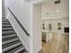 Open-concept layout with staircase and view of the kitchen, promoting a sense of spaciousness and connectivity at 241 Martin Spring Rd, Lawrenceville, GA 30045